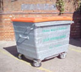 A large trade waste bin with an orange lid